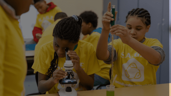 Image of students in laboratory environment, during hands-on science experiment.